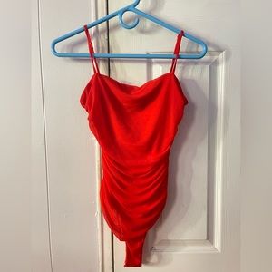 Red ruffled body suit. Has been worn.